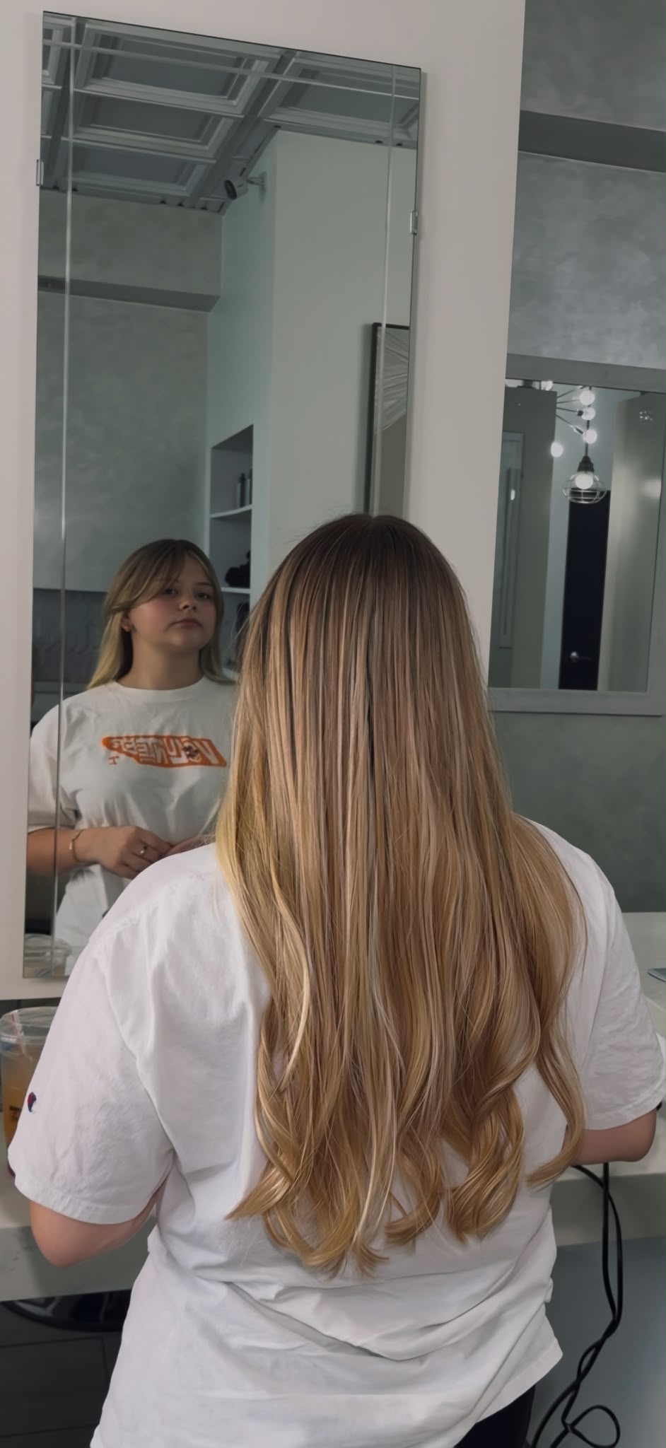 Rooted blonde hair with blended beige and honey dimension