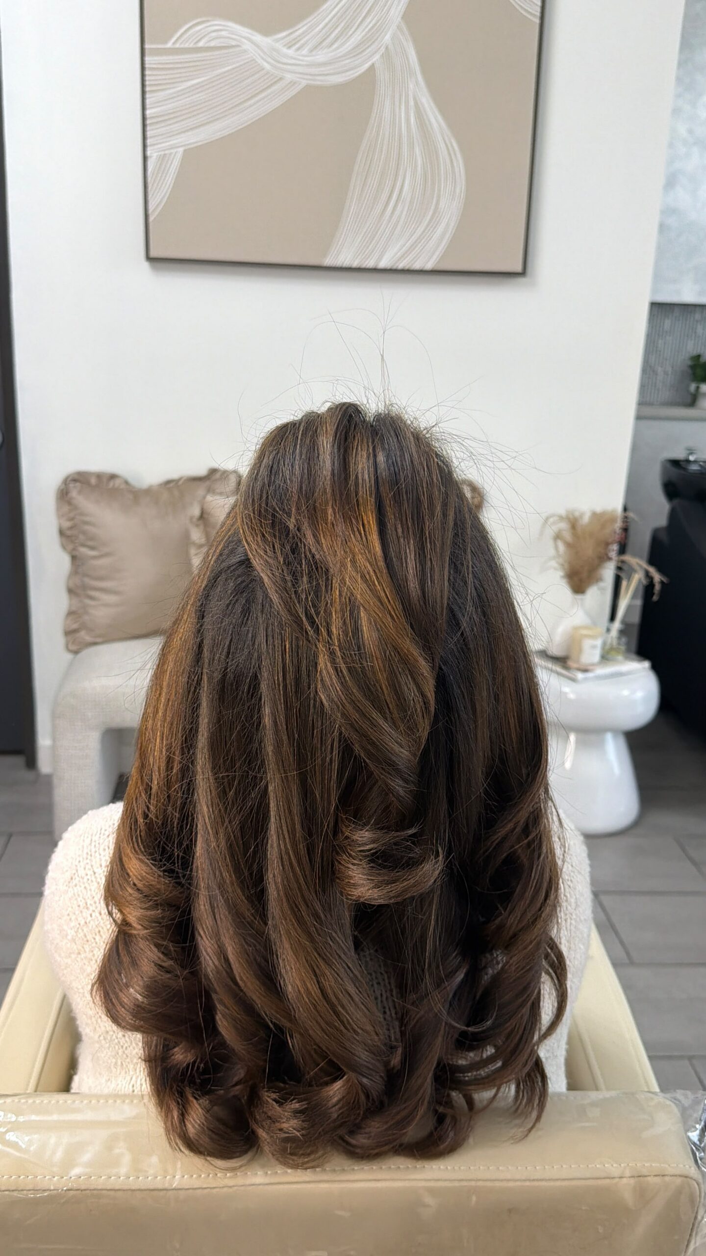 Long brunette hair with caramel dimension and curled layers