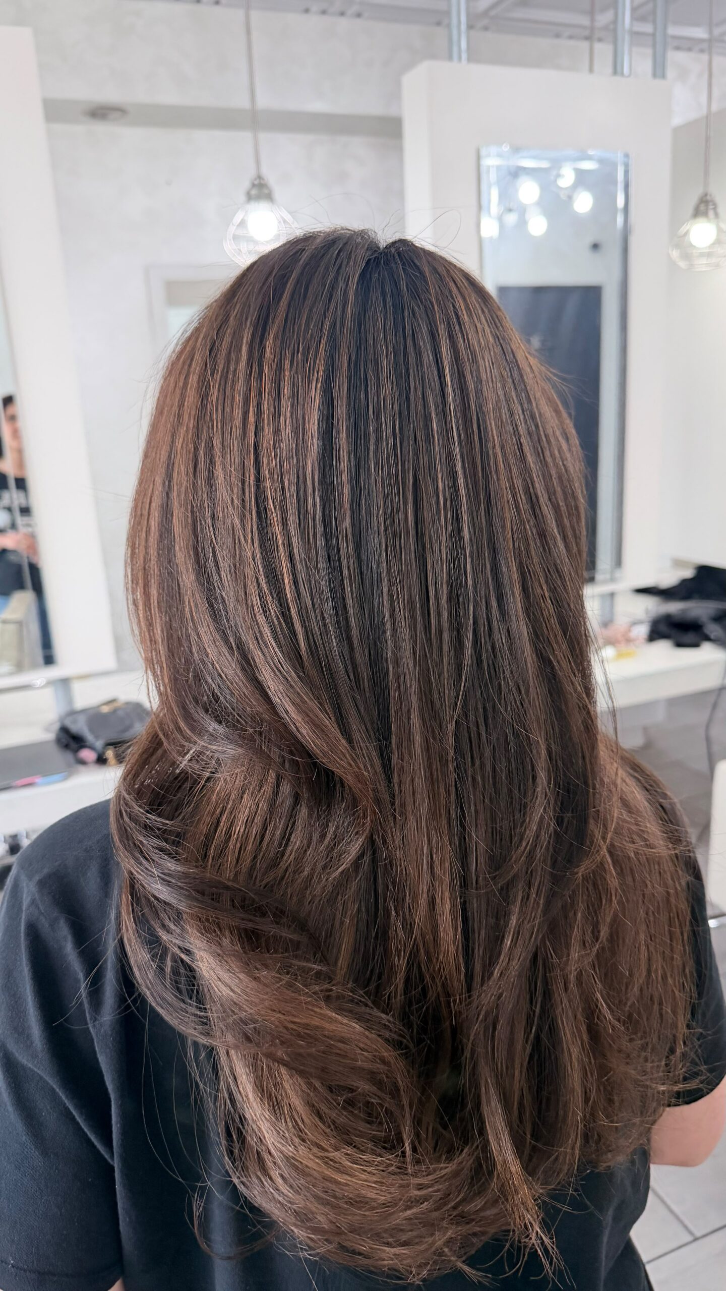 Subtle warm highlights through brunette hair